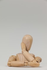 Wooden figurine leaning on table