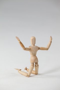 Wooden figurine kneeling with arms spread wide
