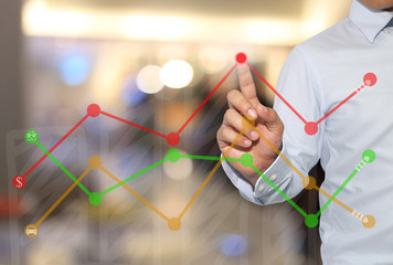 Finger of businessman touch to the peak of business graph on abs