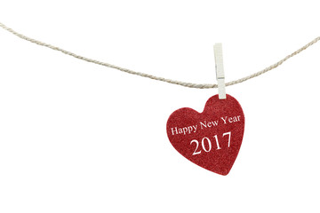 Red heart with text of Happy new year 2017 hanging on hemp rope