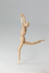 Wooden figurine exercising on floor