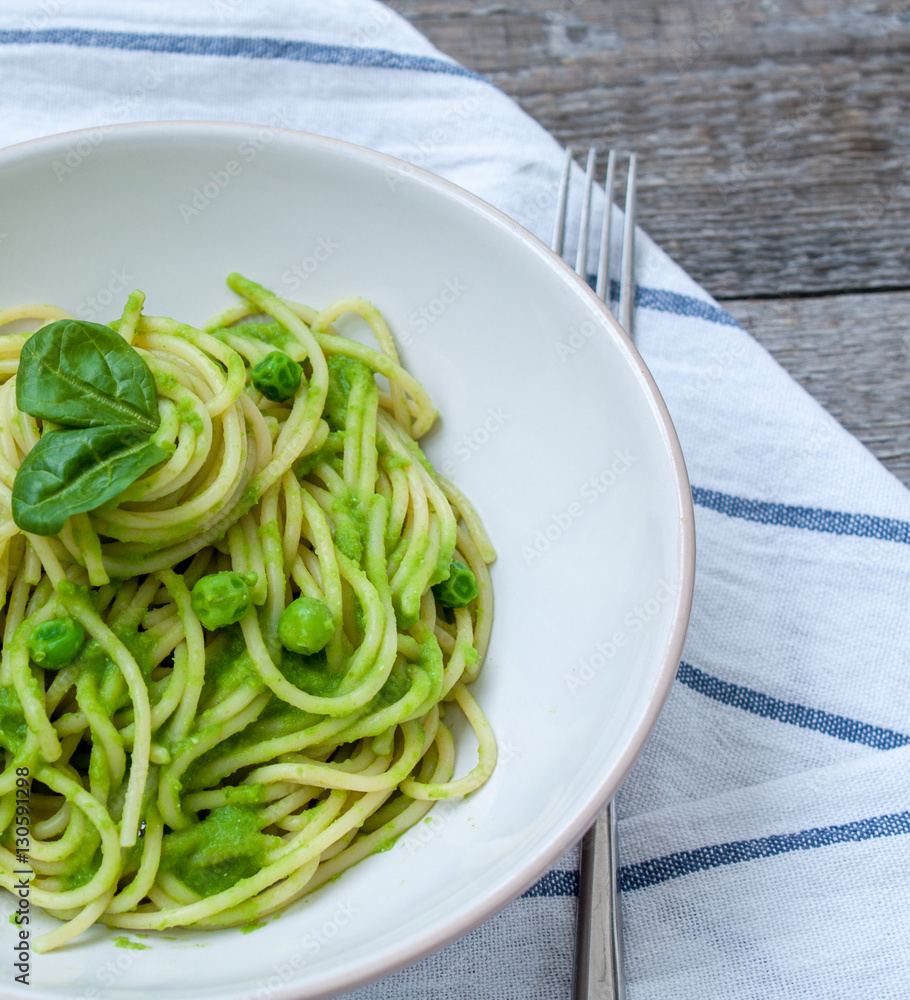 Wall mural Green pasta with pesto and peas. Love for a healthy raw food concept.