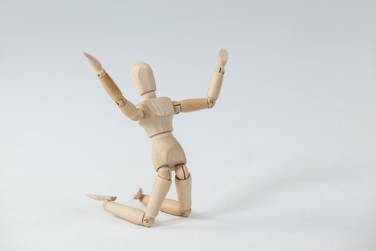 Wooden figurine kneeling with arms spread wide