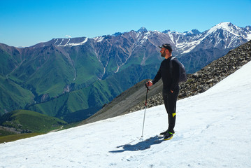 Fototapeta na wymiar Hiker trekking in the mountains. Sport and active life