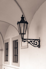 Prague street architecture. Ancient street light on wall of house