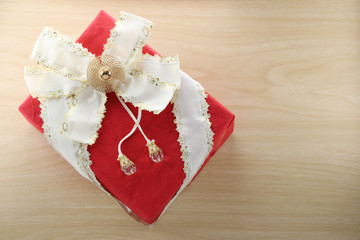 Gift box is placed on wooden floor.