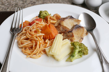 Fried Spaghetti and grilled fish on white dish.