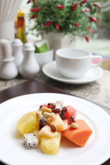 Fruit salad on white dish.