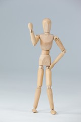 Wooden figurine standing and showing his fist