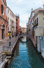 Fototapeta na wymiar Venice (Italy) - The city on the sea. Here a suggestive alley with canal at the dawn