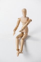 Wooden figurine sitting with his hands forward