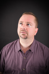 Obraz premium Handsome man doing different expressions in different sets of clothes: thinking