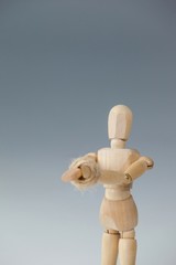 Hands of wooden figurine tied with a rope