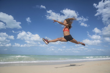 Girl dancing leaping on beach