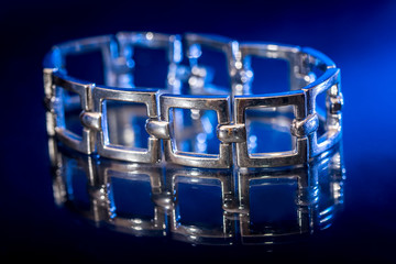 Fashion silver female bracelet isolated on black.