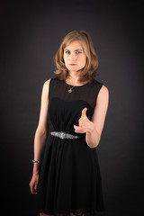 Beautiful woman doing different expressions in different sets of clothes: gun sign