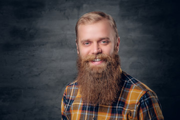 Portrait of redhead bearded male in a yellow plaid shirt.