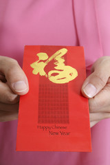 Lady holding chinese new year angpow money envelope in occasion of chinese new year