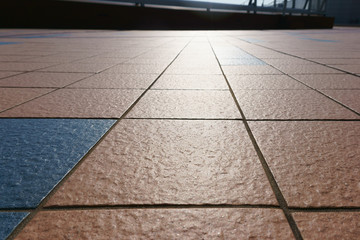 patterned paving tiles, cement brick floor background and sunlig