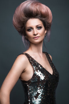 Beautiful girl in evening dress with avant-garde hairstyles. Beauty the face. Photos shot in the studio.