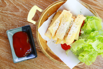 fried chicken wings or fried chicken with vegetable and sauce on white dish. fried chicken is bad cholesterol and bad for health when eating a lot. fast food for who work in city or office.