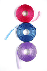 three skeins satin ribbon isolated on white background