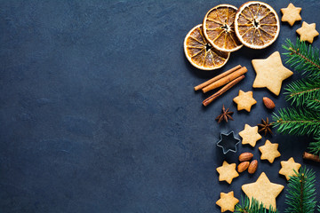 Christmas or New Year background with gingerbread cookies, stars shaped cookies, spices, almond...
