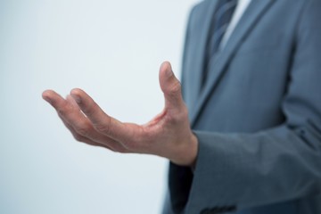 Mid section of a businessman offering a helping hand