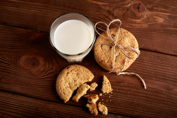 Cookies and milk. Chocolate chip cookies and a glass of milk. Vintage look. Tasty cookies and glass of milk on rustic wooden background. Food, junk-food, culinary, baking and eating concept