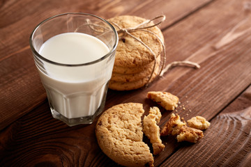 Cookies and milk. Chocolate chip cookies and a glass of milk. Vintage look. Tasty cookies and glass of milk on rustic wooden background. Food, junk-food, culinary, baking and eating concept