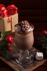 Christmas composition with hot cocoa, gift and fir-tree branch