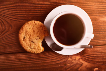 Coffee and Homemade cookies with chocolate. Handmade Chocolate cookies and cup of espresso on wooden table. Pile of delicious chip cookies. Christmas cookies. Biscuits. Oat biscuits.