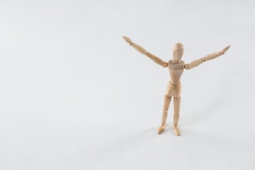 Wooden figurine standing with arms spread
