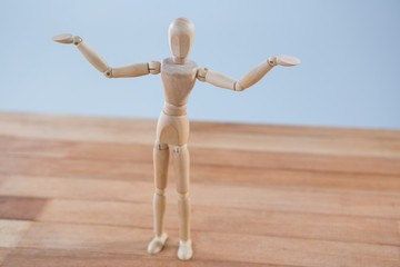 Fototapeta premium Wooden figurine standing with arms spread