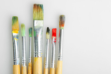 Paint brushes on a grey background.