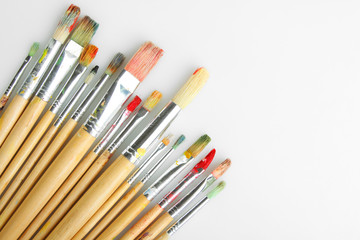 Obraz premium Paint brushes on a grey background.