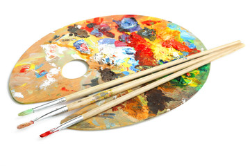 Wooden art palette  and a brush on white background.