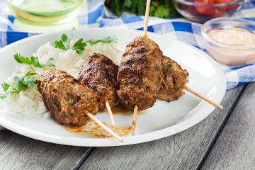 Barbecued kofta with rice on a plate