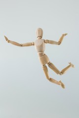 Wooden figurine jumping in the air