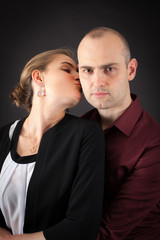 Obraz premium Beautiful couple doing different expressions in different sets of clothes: kiss