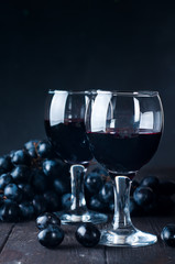 Red wine in glasses with grape