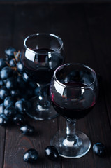 Red wine in glasses with grape