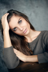 Obraz premium Portrait of a beautiful young and sexy girl in a sweater