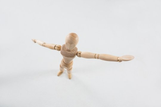 Wooden figurine standing with arms spread