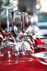 Christmas lunch. Crystal glasses on red tablecloth.