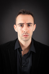 Handsome man doing different expressions in different sets of clothes: sad