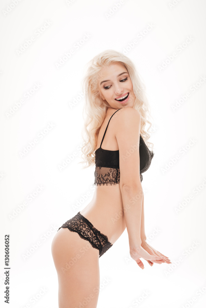 Sticker Side view of a playful woman posing in black lingerie