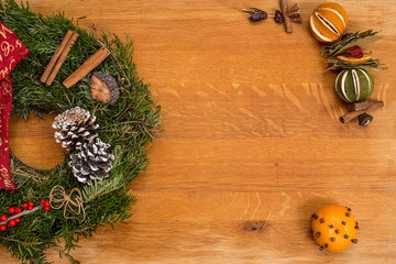 Christmas wreath and decoration on wooden background.