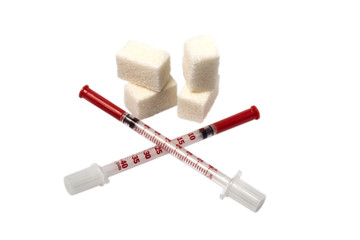 Sugar as the main problem with diabetes, two crossed medical insulin syringes, red indications and caps. Concept of diabetes problem. Isolated on white background.