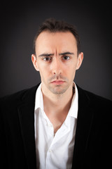 Fototapeta premium Handsome man doing different expressions in different sets of clothes: sad